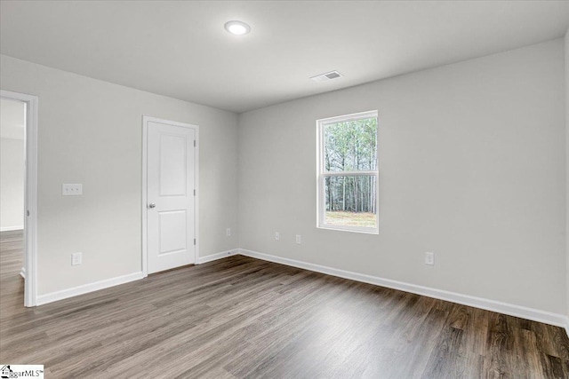 spare room with hardwood / wood-style floors