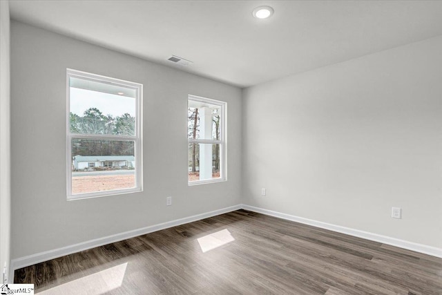 unfurnished room featuring dark wood-type flooring