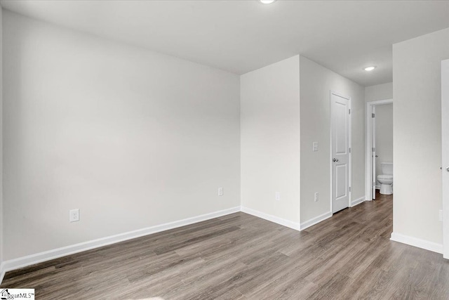 spare room featuring dark wood-type flooring