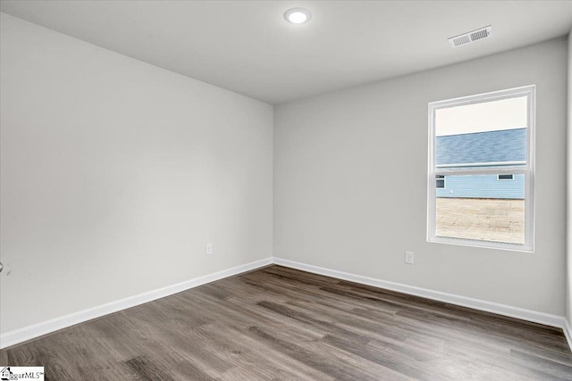 unfurnished room with hardwood / wood-style floors
