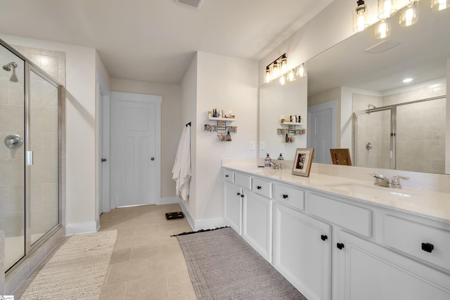 bathroom featuring tile patterned floors, vanity, and a shower with door