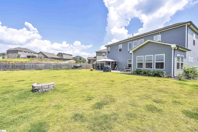 rear view of property with a yard