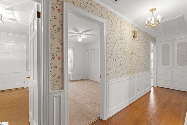 entrance foyer featuring light hardwood / wood-style flooring, a chandelier, and ornamental molding