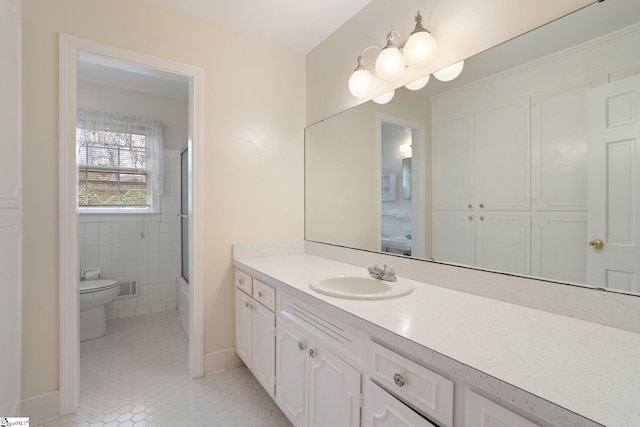 full bathroom with vanity, combined bath / shower with glass door, tile patterned flooring, toilet, and tile walls