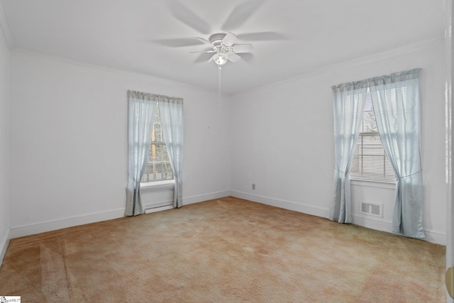 carpeted empty room featuring ceiling fan and crown molding