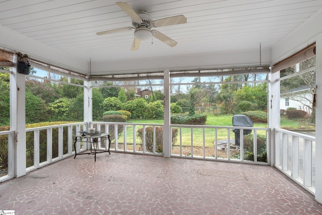 unfurnished sunroom featuring ceiling fan