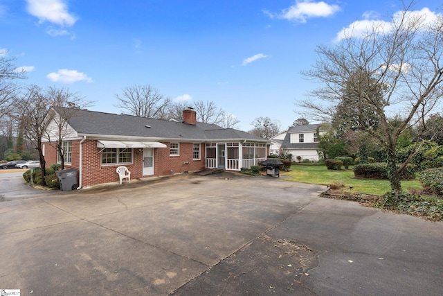 view of front of home featuring a sunroom