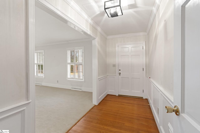 corridor with light colored carpet and crown molding