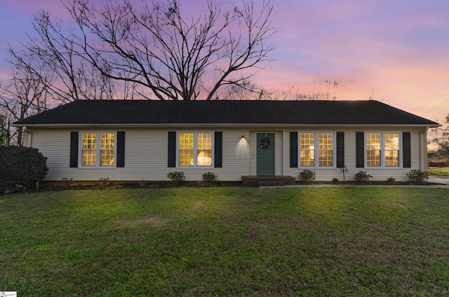 single story home featuring a yard