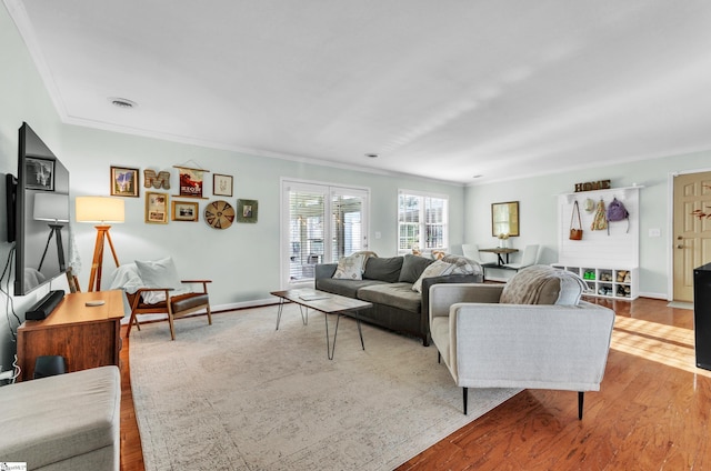 living room featuring light hardwood / wood-style flooring and ornamental molding