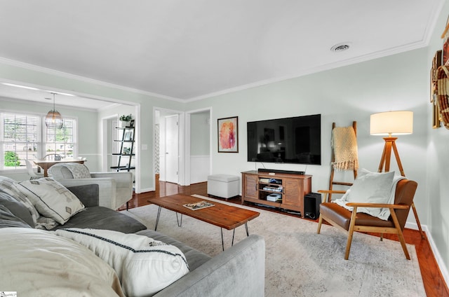 living room featuring crown molding and wood-type flooring