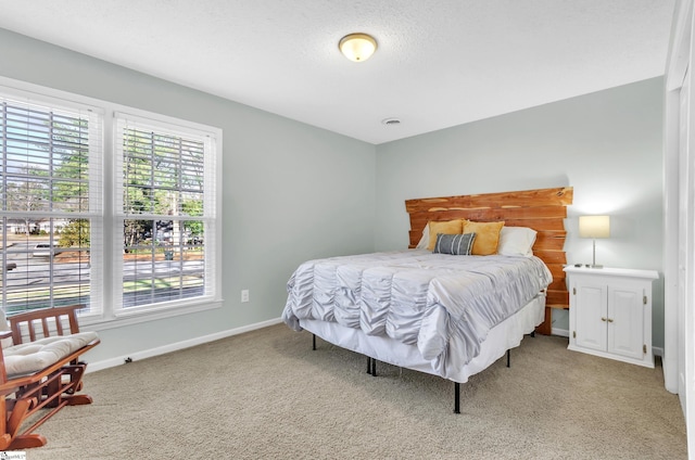 bedroom featuring multiple windows and carpet