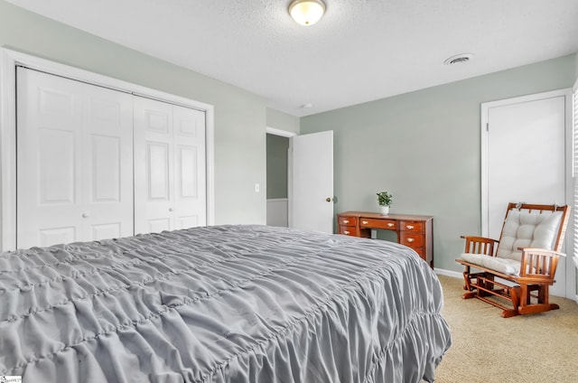 carpeted bedroom featuring a closet and a textured ceiling