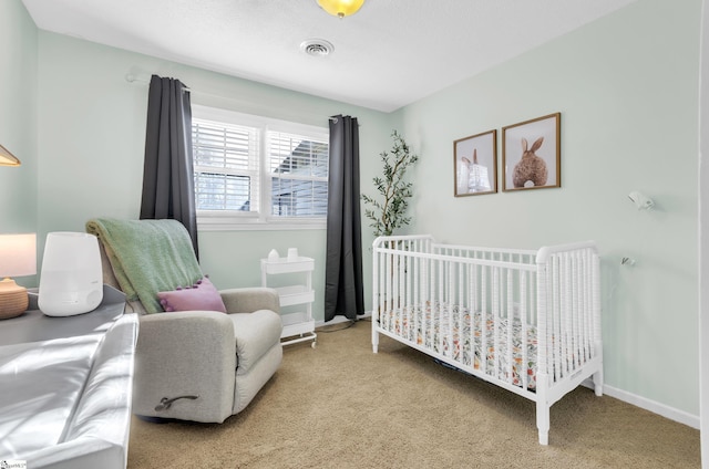 carpeted bedroom with a nursery area