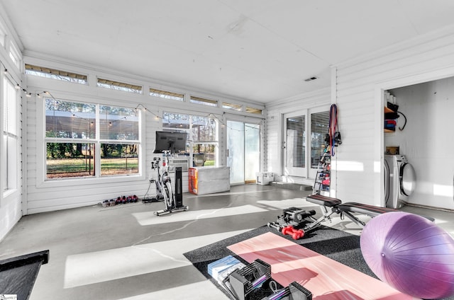 exercise room featuring wood walls and ornamental molding