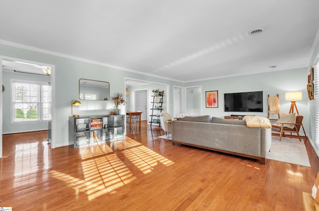 living room featuring light hardwood / wood-style floors and ornamental molding