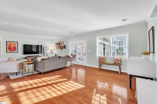 living room featuring crown molding and light hardwood / wood-style floors