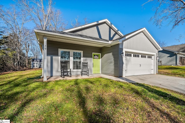 view of front of property with a front lawn, a porch, and a garage