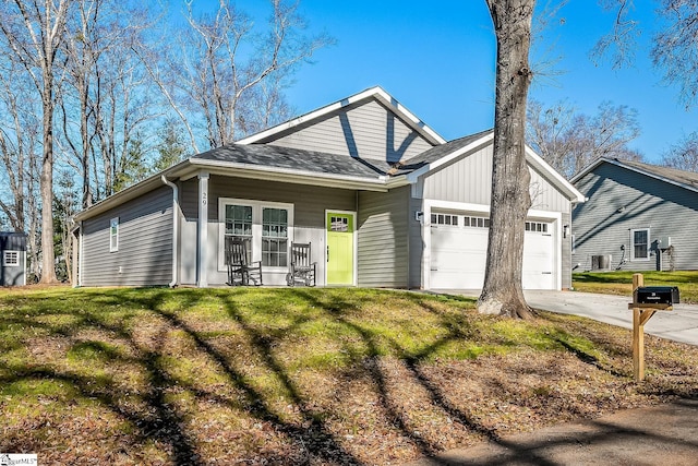 view of front facade featuring a front yard, a porch, and a garage