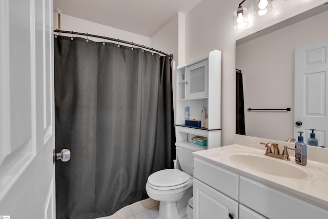 bathroom featuring tile patterned flooring, vanity, and toilet