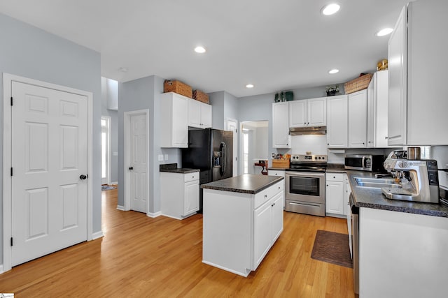 kitchen featuring white cabinets, light wood-type flooring, a center island, and stainless steel appliances