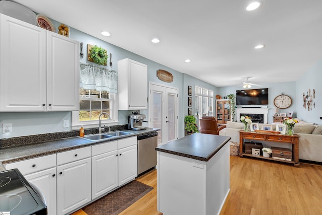 kitchen with white cabinetry, dishwasher, light wood-type flooring, and sink