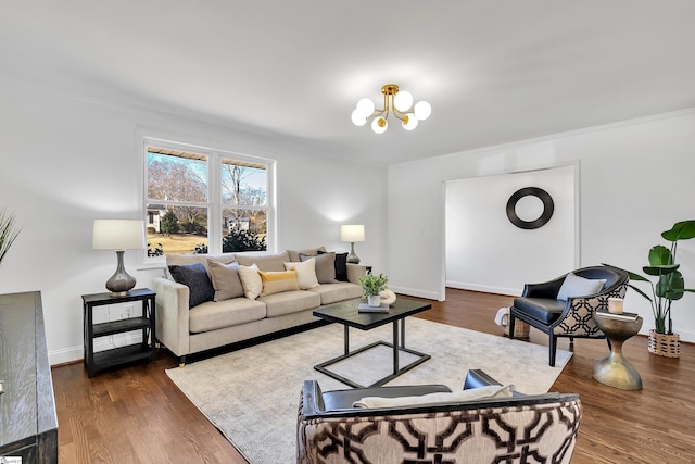 living room with dark hardwood / wood-style flooring and an inviting chandelier