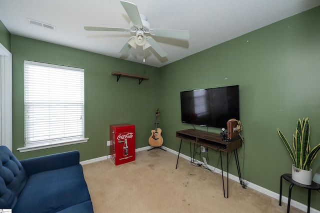 living room featuring ceiling fan and light colored carpet