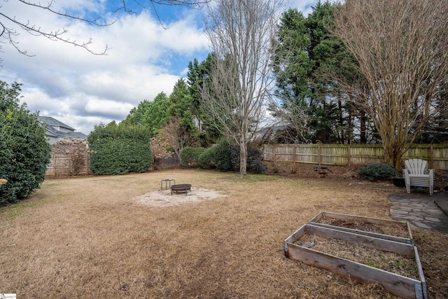 view of yard with an outdoor fire pit