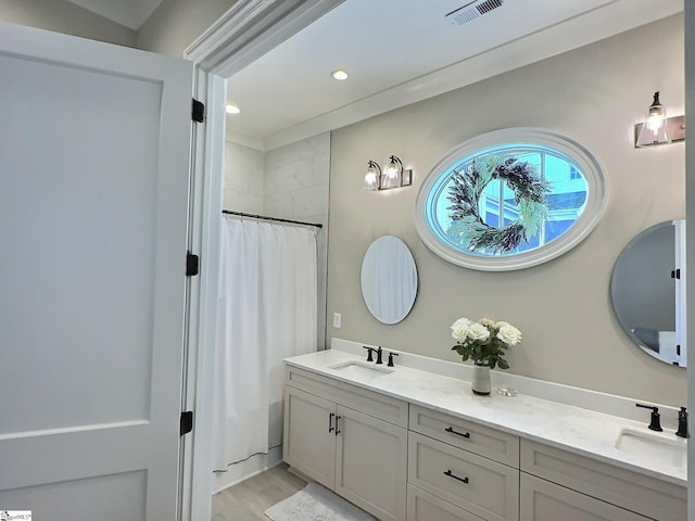 bathroom featuring shower / bathtub combination with curtain, vanity, and wood-type flooring