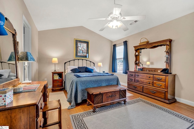 bedroom featuring ceiling fan, vaulted ceiling, and light hardwood / wood-style flooring