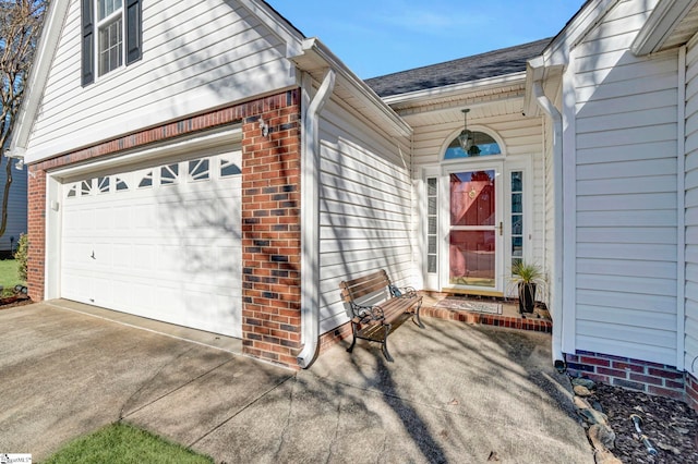 view of exterior entry with a garage