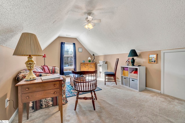 sitting room with ceiling fan, light colored carpet, a textured ceiling, and vaulted ceiling