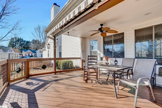 wooden deck featuring ceiling fan