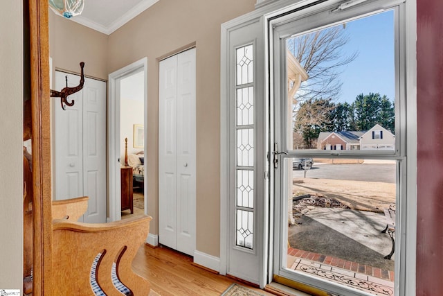 doorway featuring light hardwood / wood-style floors and ornamental molding