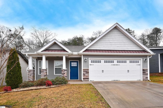 craftsman-style home featuring a front lawn, a porch, and a garage