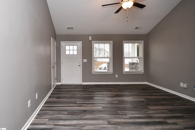 foyer entrance with ceiling fan, dark hardwood / wood-style flooring, and vaulted ceiling