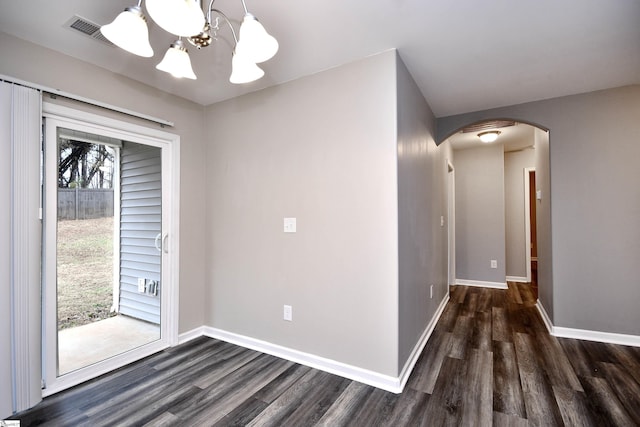 interior space with a chandelier and dark hardwood / wood-style floors