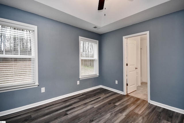 spare room with hardwood / wood-style floors and ceiling fan