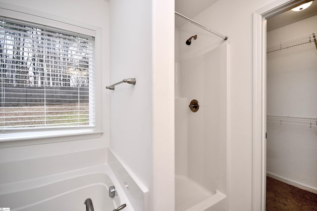 bathroom featuring shower with separate bathtub