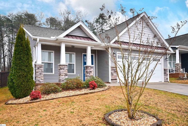 craftsman-style home featuring a garage and a front lawn