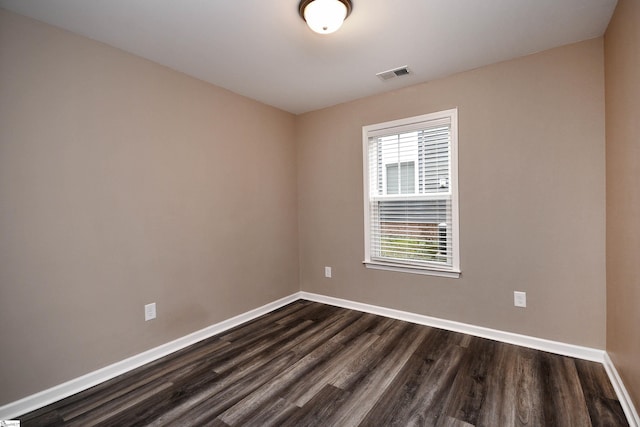 empty room featuring dark wood-type flooring