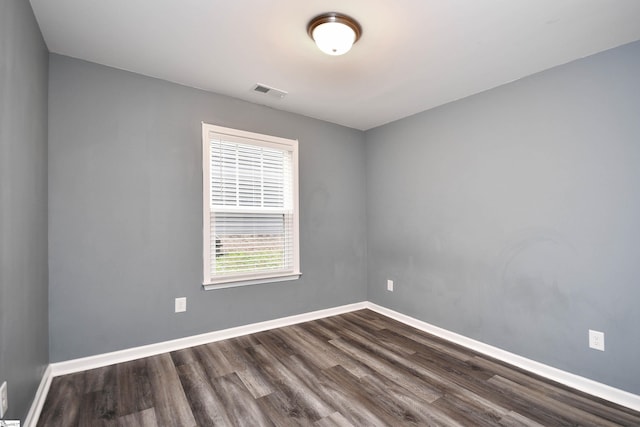 spare room with dark hardwood / wood-style flooring