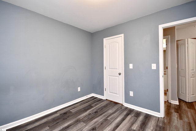 unfurnished bedroom featuring dark wood-type flooring