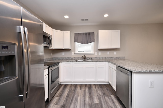 kitchen with white cabinets, sink, kitchen peninsula, and stainless steel appliances