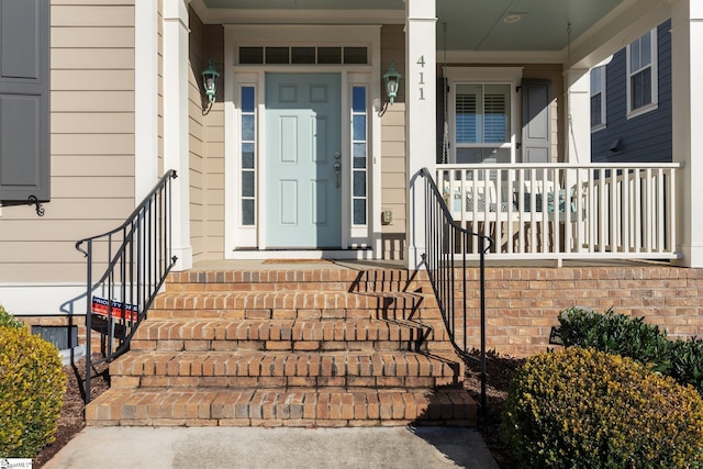 view of exterior entry featuring a porch