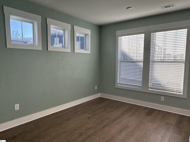 unfurnished room with dark hardwood / wood-style floors