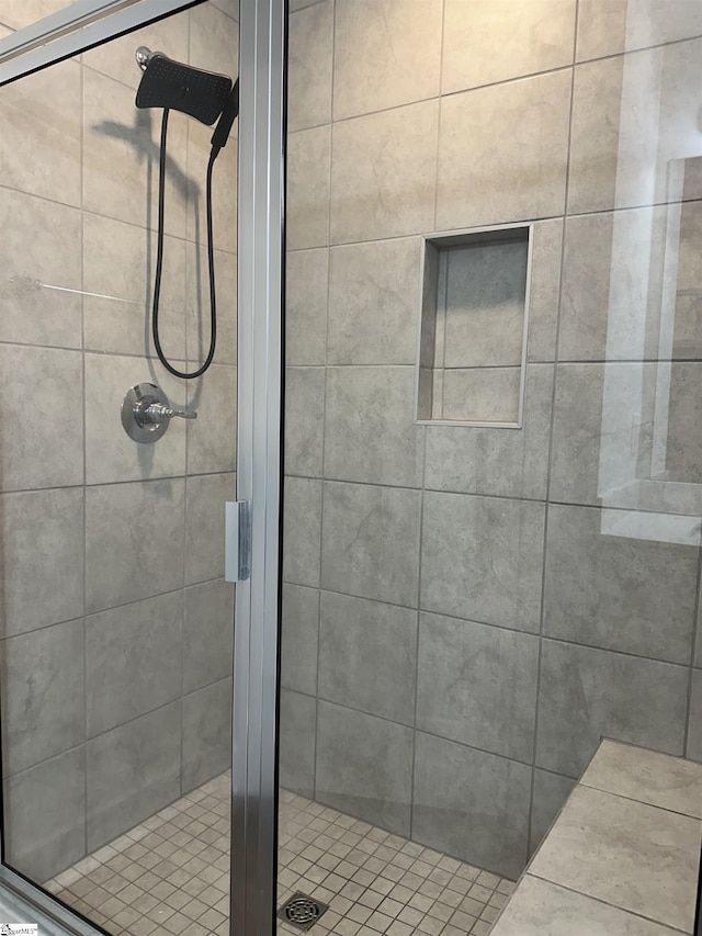 bathroom with a shower with shower door