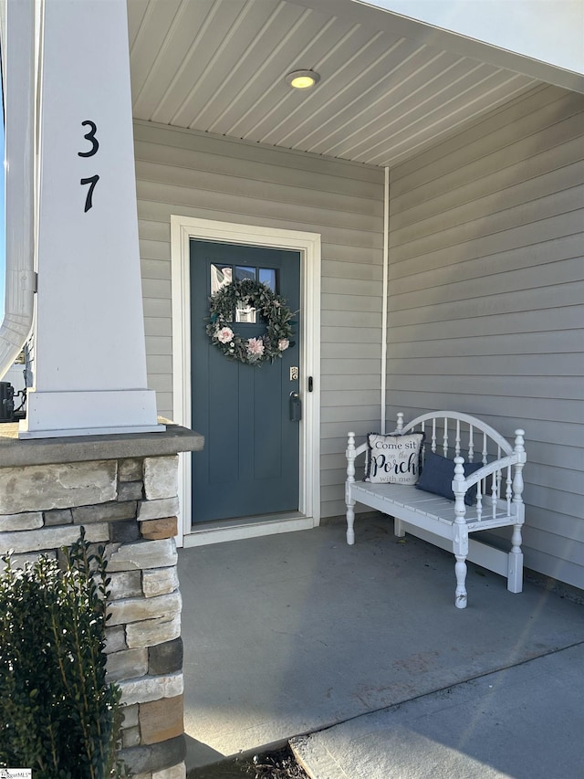 view of exterior entry featuring a porch