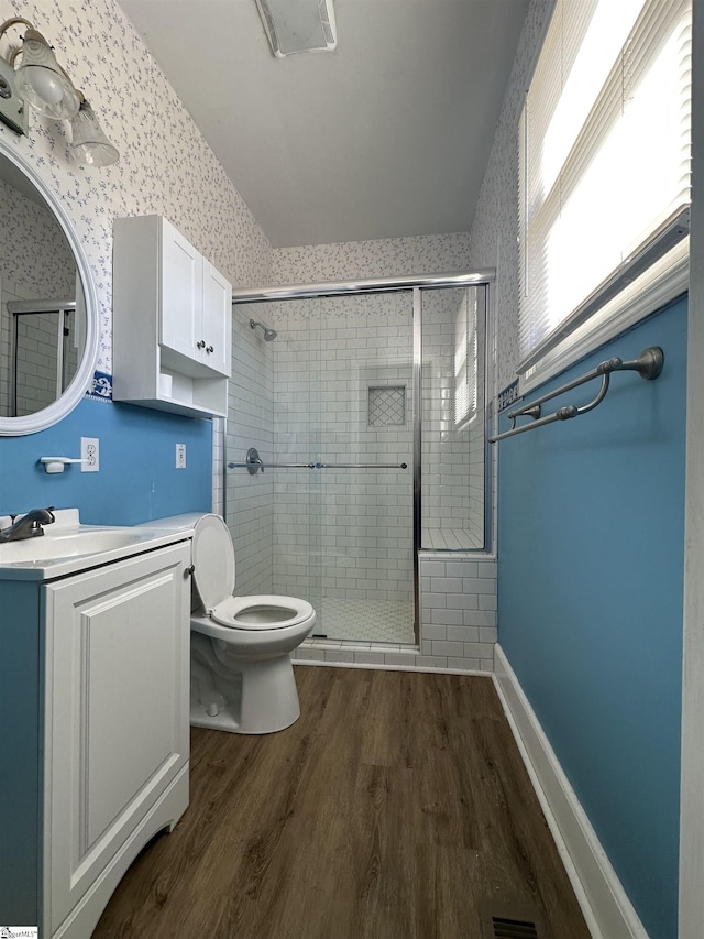 bathroom with vanity, hardwood / wood-style flooring, toilet, and walk in shower